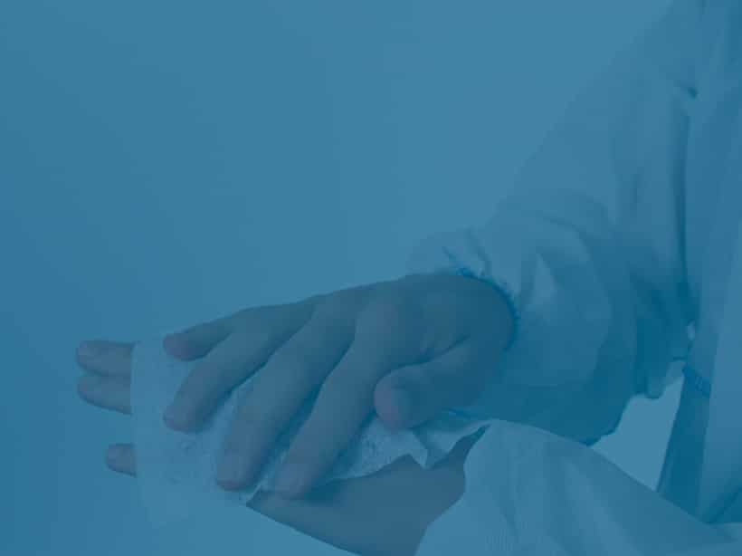 Hands in a monochrome blue tint, where one hand is wrapping a piece of cloth or gauze around the wrist of the other hand.
