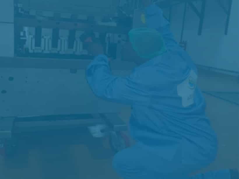 Rear image of a Man with an advanced cleaning services jacket sanitising food equipment with the I-clean system.